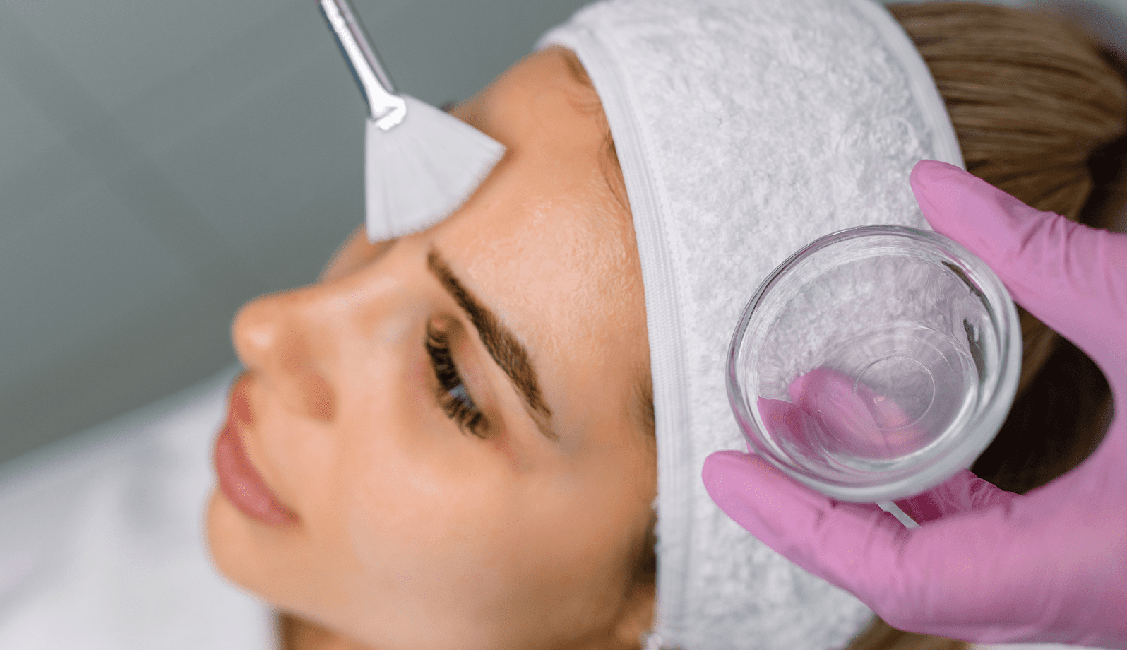 GettyImages-1170207585-35 A woman undergoing a facial treatment with a skincare device.