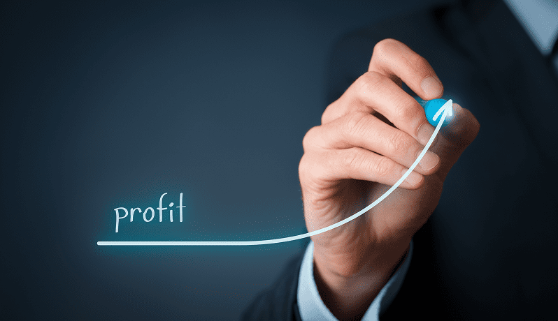 Hand drawing an upward profit growth graph with a blue marker.