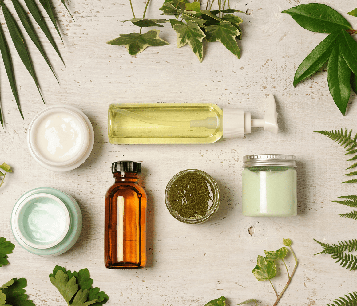 treatment-1 5 Natural skincare products with plant ingredients on a wooden surface.