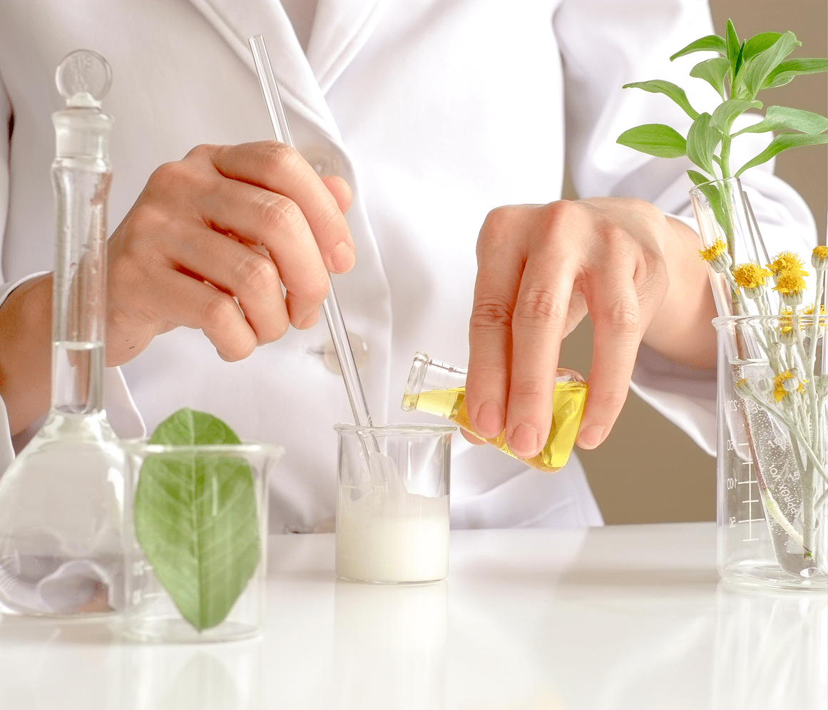 treatment-1 6 Scientist extracts lemon juice in a lab setting with plants and glassware.